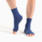 Model wearing open-toe grip socks during yoga movement and balance